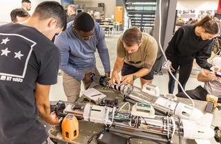 Underwater operators from the US Navy and civilian engineers conduct work on an underwater vehicle before it is launched during Exercise AUKUS at Pittwater, New South Wales, November 2023.